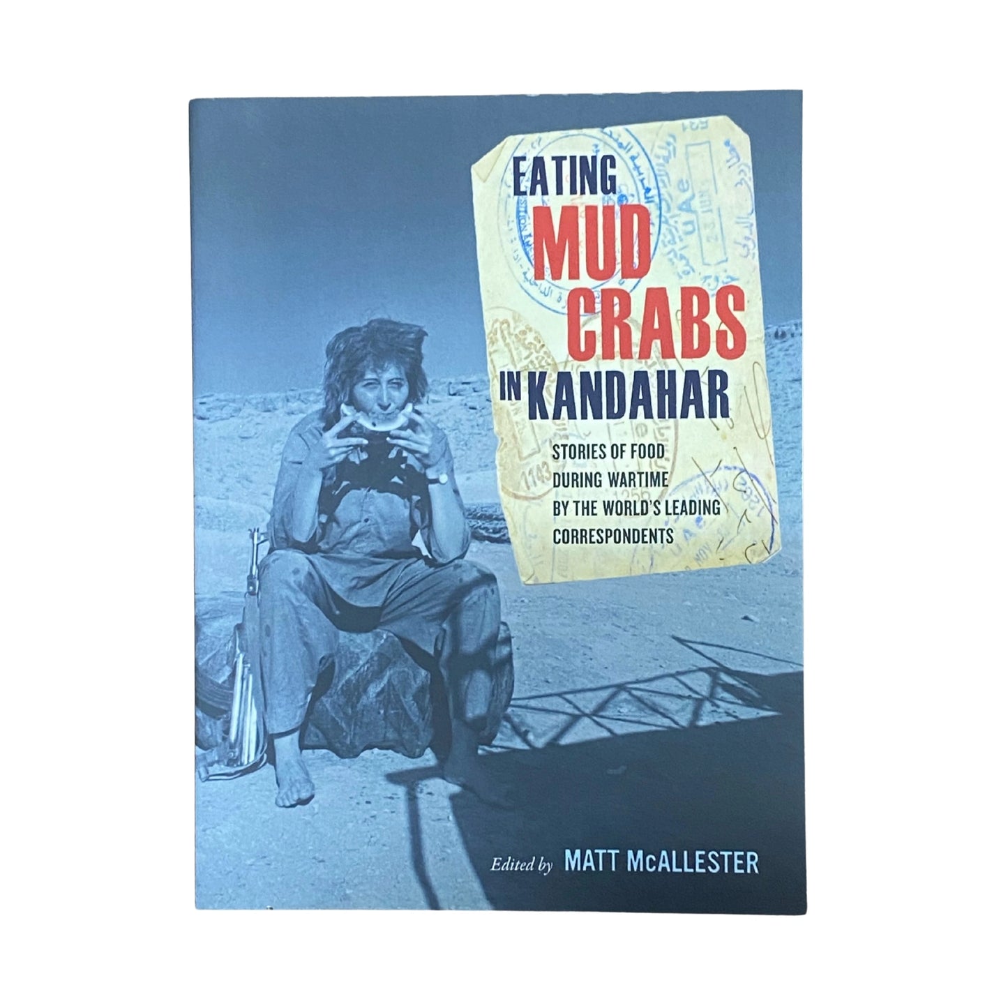 Book cover of 'Eating Mud Crabs in Kandahar' with a blue filter effect.